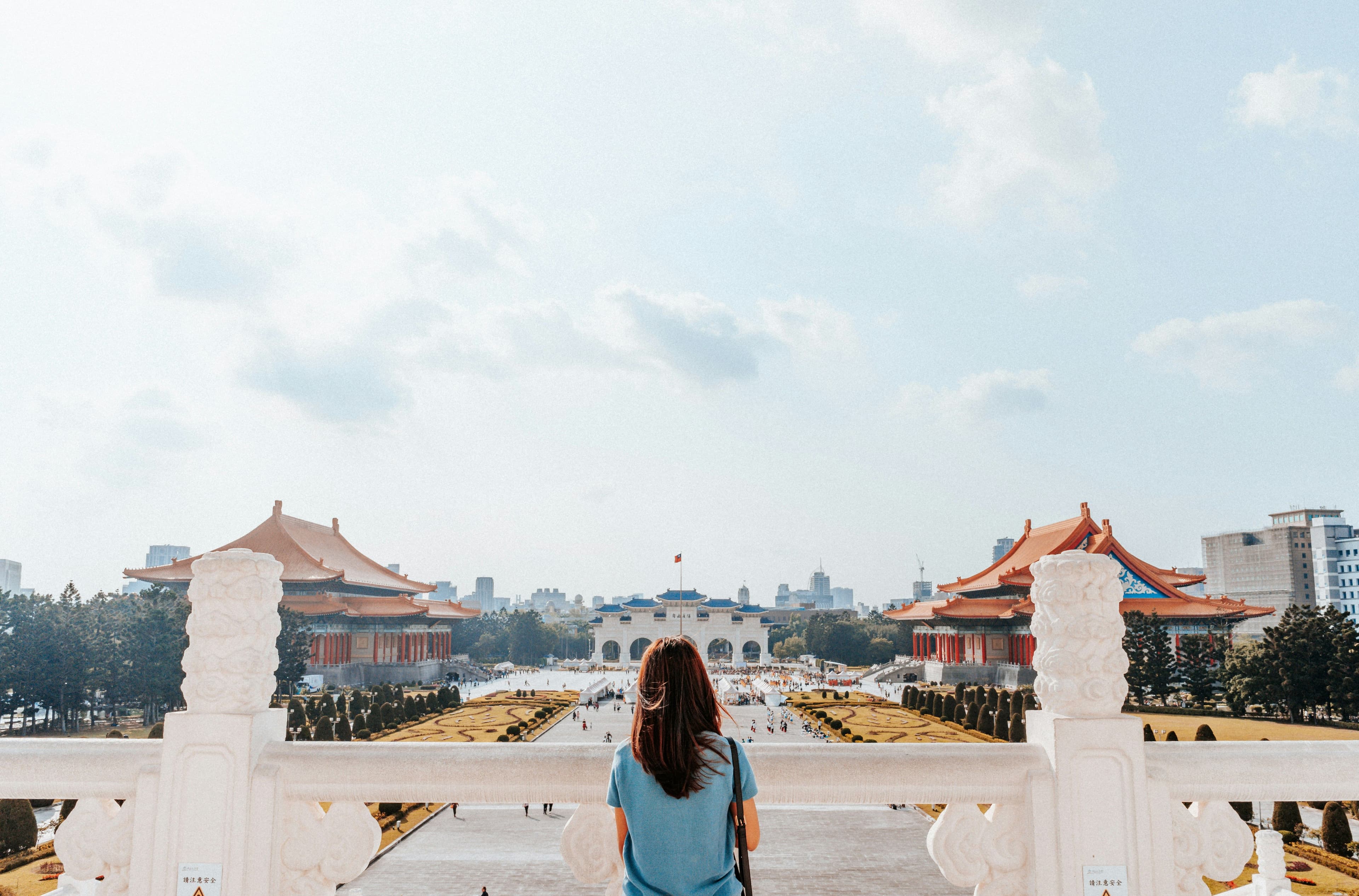 Solo female traveler exploring the Grand Palace in Bangkok, Thailand - one of the best destinations for first-time Southeast Asia travel